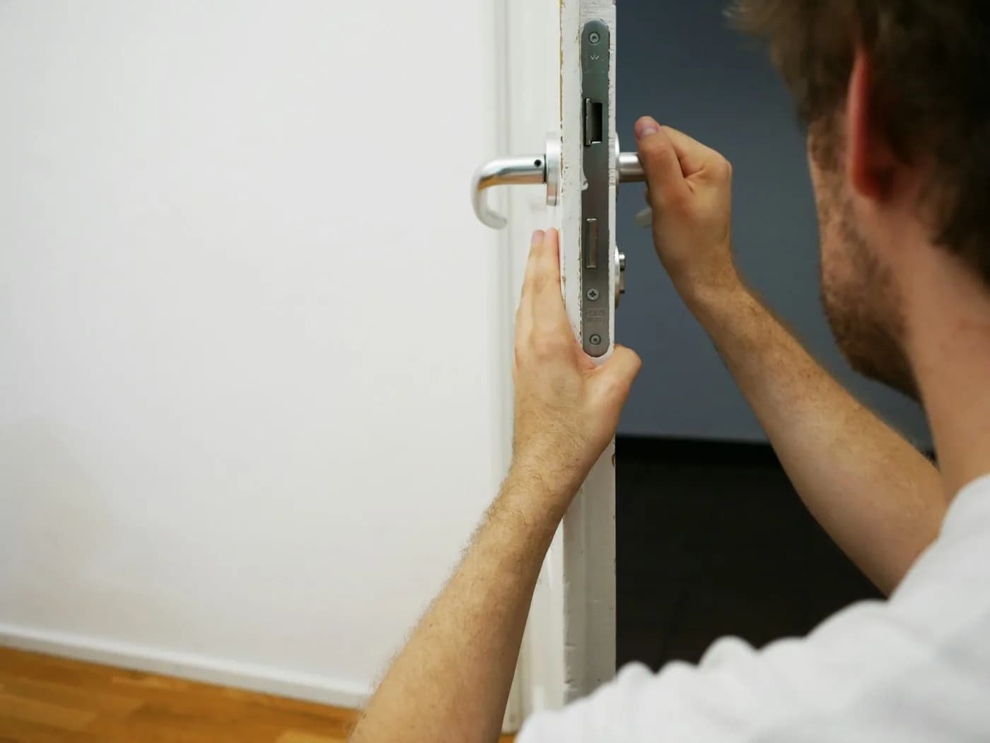 Lock hardware being adjusted on a commercial door